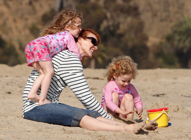 Marcia Cross, beach, white and black striped top, denim capris, sunglasses, sand buckets, sand pails, twin daughters