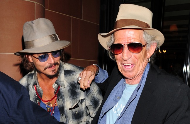 Johnny Depp, plaid shirt, blue tint sunglasses, hat, necklaces, blue shirt, tan hat, Keith Richards, hat, skull ring, black jacket, blue shirt,