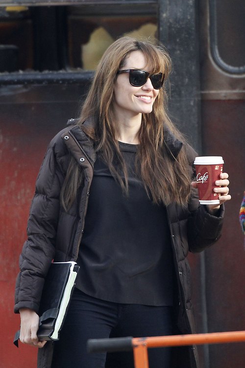 Angelina Jolie, sunglasses, coffee, black shirt, black leggings, black coat