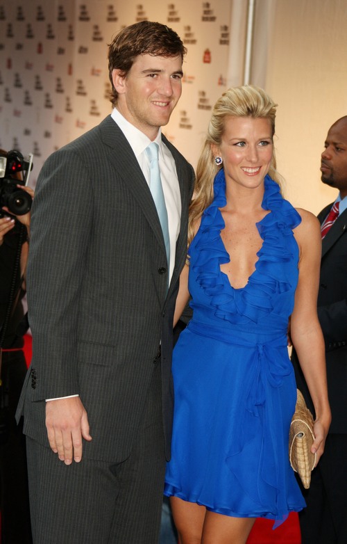 eli manning, dark suit, abby manning blue dress