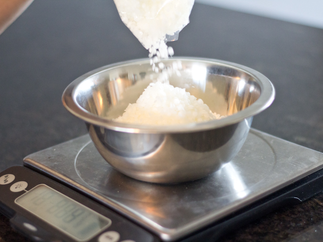 measuring out the wax to make your own hair pomade