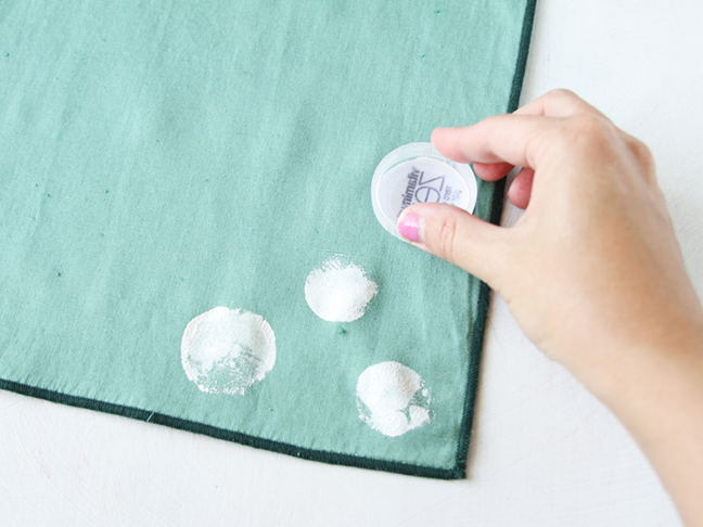 Use plastic bottle caps to stamp napkins