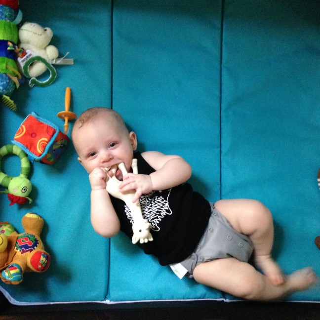 Closeup of baby laying in the 4moms breeze play yard