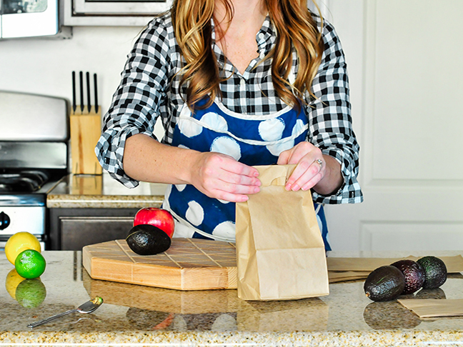 woman closing paper bag