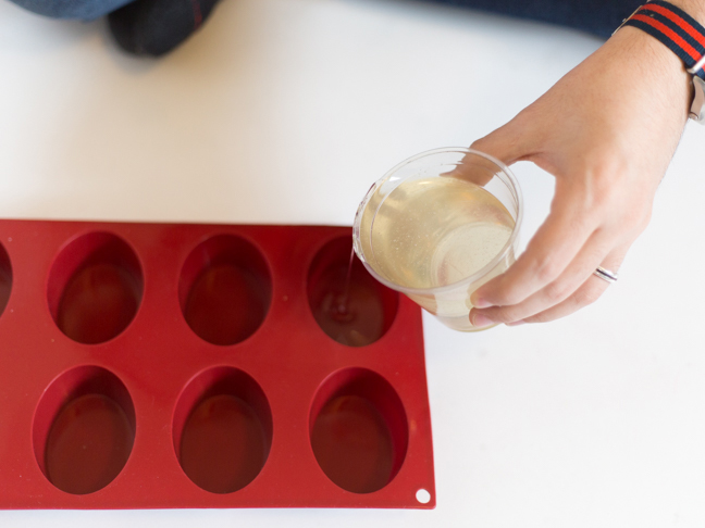 hand-pouring-resin-mix-into-mold