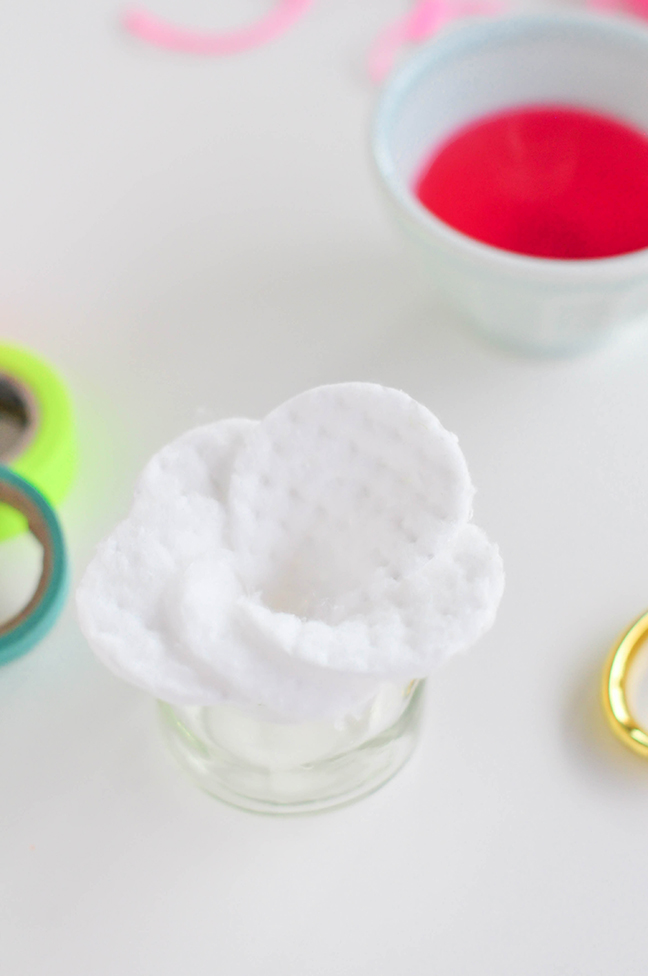 folding round cotton pads in a flower petal shape