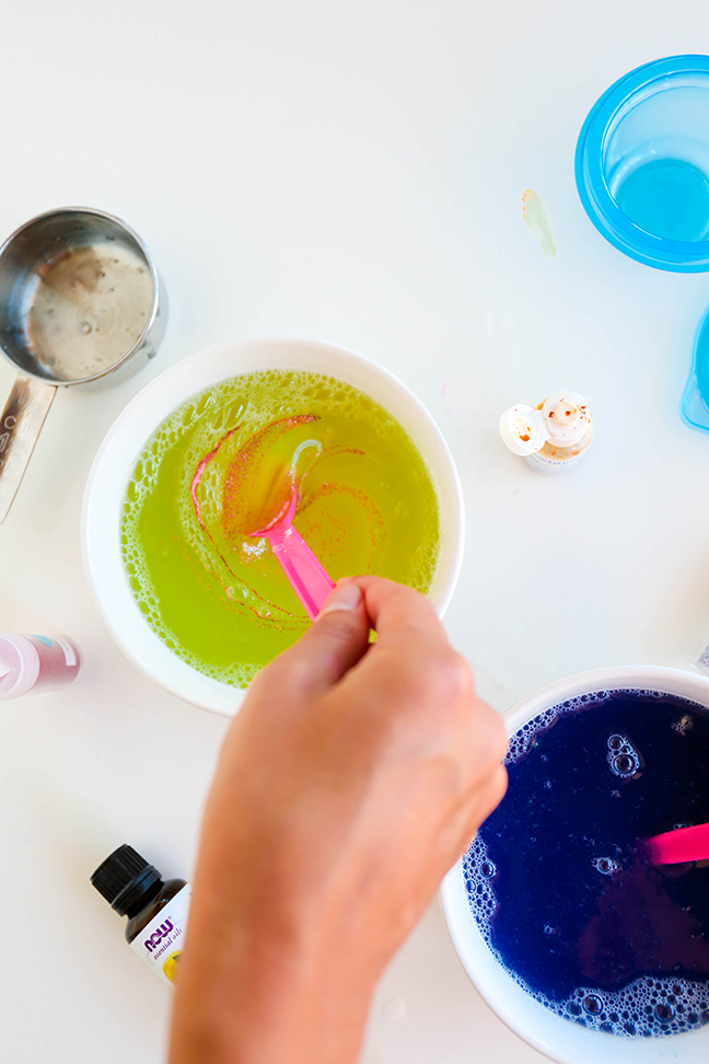 stirring pink glitter into yellow liquid