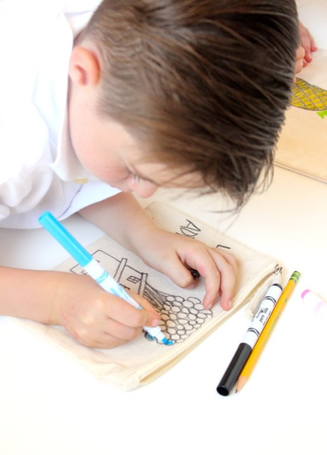 boy-coloring-balloons-on-a-canvas-cosmetic-bag