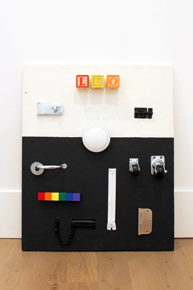 diy-black-and-white-busy-board-for-toddlers-with-hardware-and-rainbow-blocks