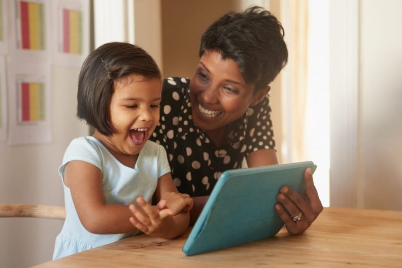 mom showing child earth rangers app on tablet