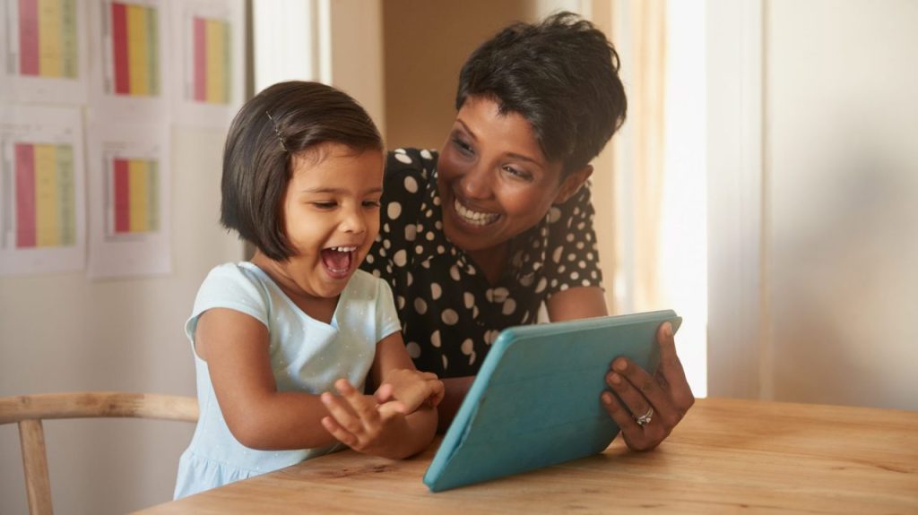 mom showing child earth rangers app on tablet