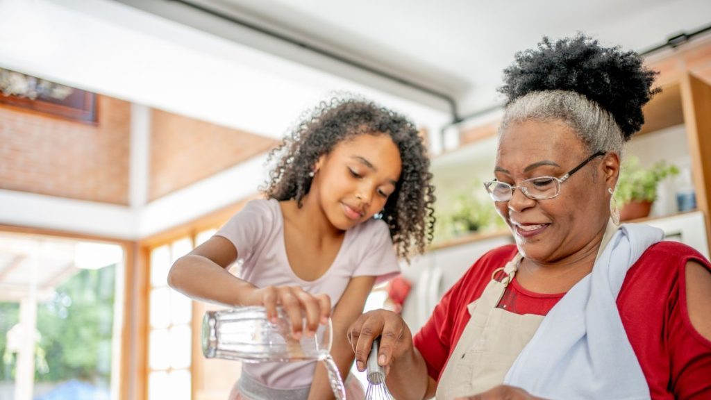Grandma and granddaughters making Christmas cookies