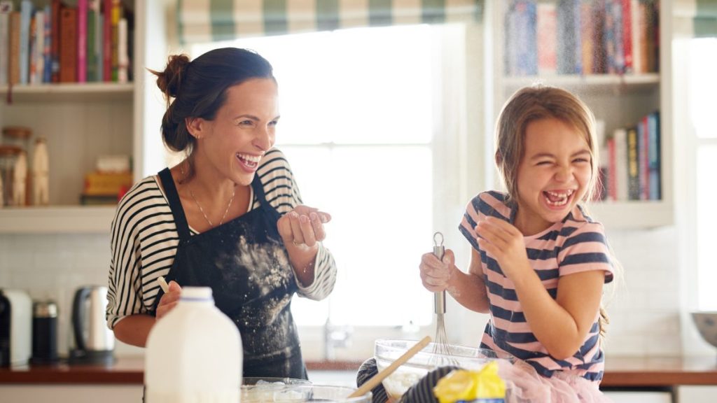 Shot of a little girl having fun baking with her mother in the kitchen