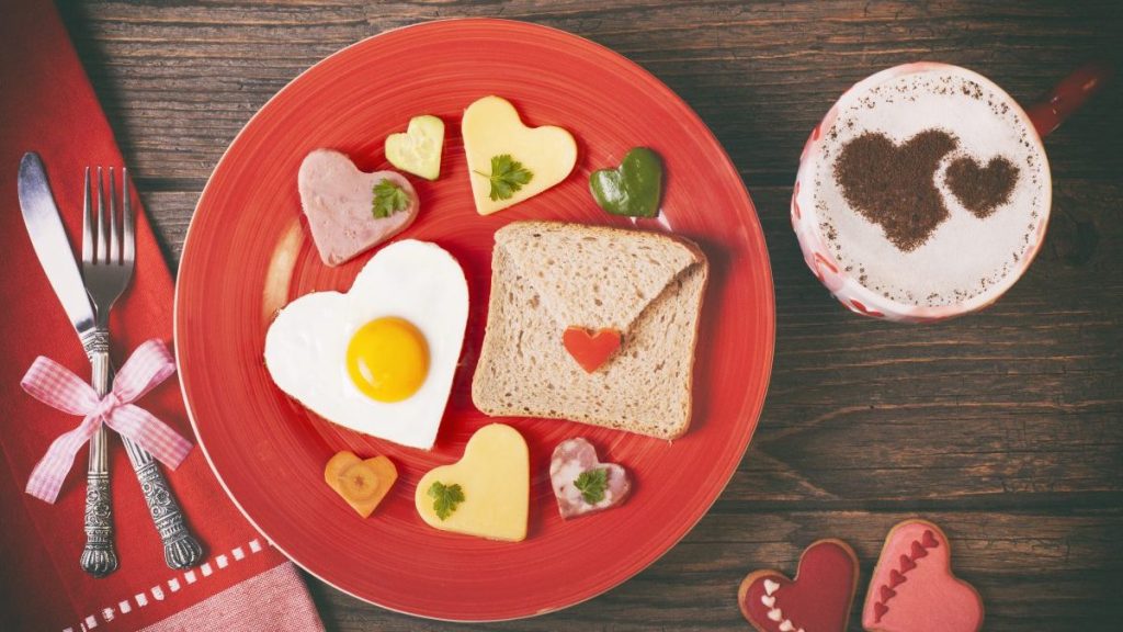 Lunch on Valentine's Day on rustic wooden table.