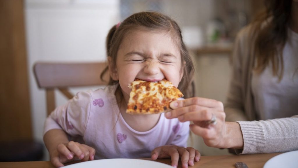 Cute girl eating pizza