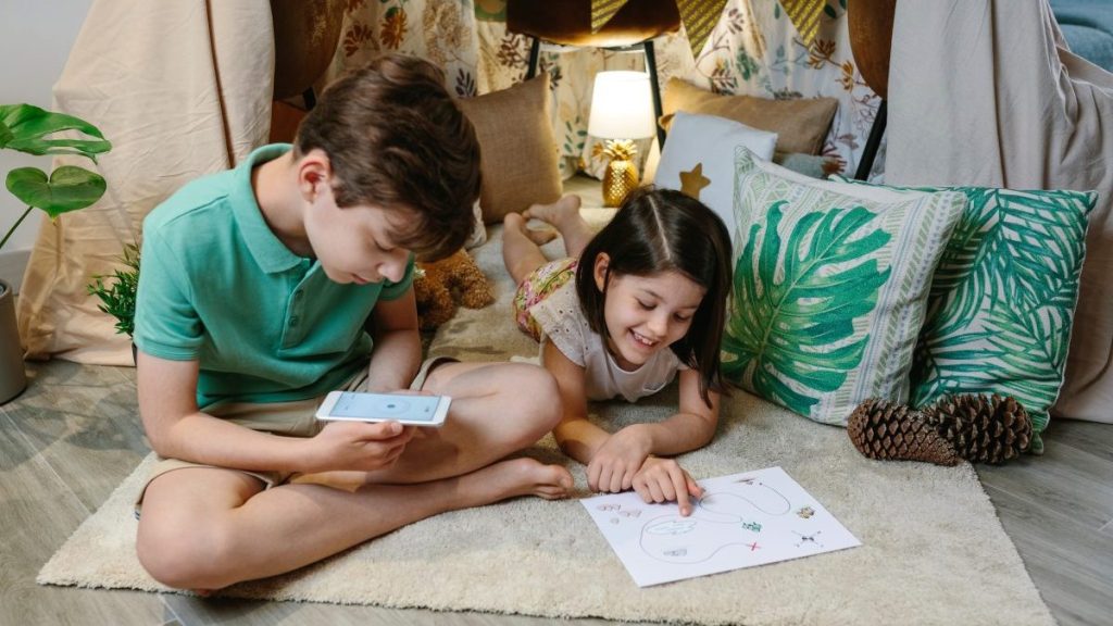 Children playing in a cozy diy tent at home