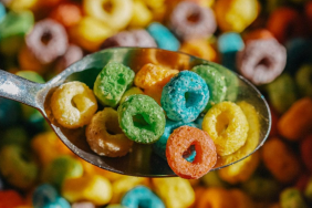 Close up of a spoon filled with colorful loo-shaped cereal