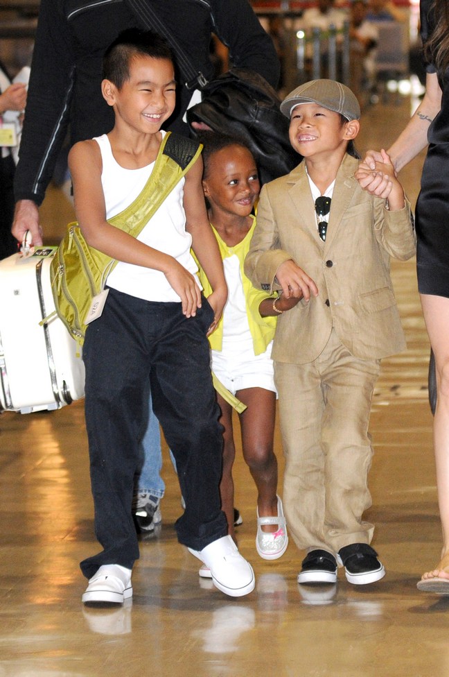 Maddox Jolie-Pitt, white tank top, black pants, green back pack, Pax Jolie-Pitt, beige suit