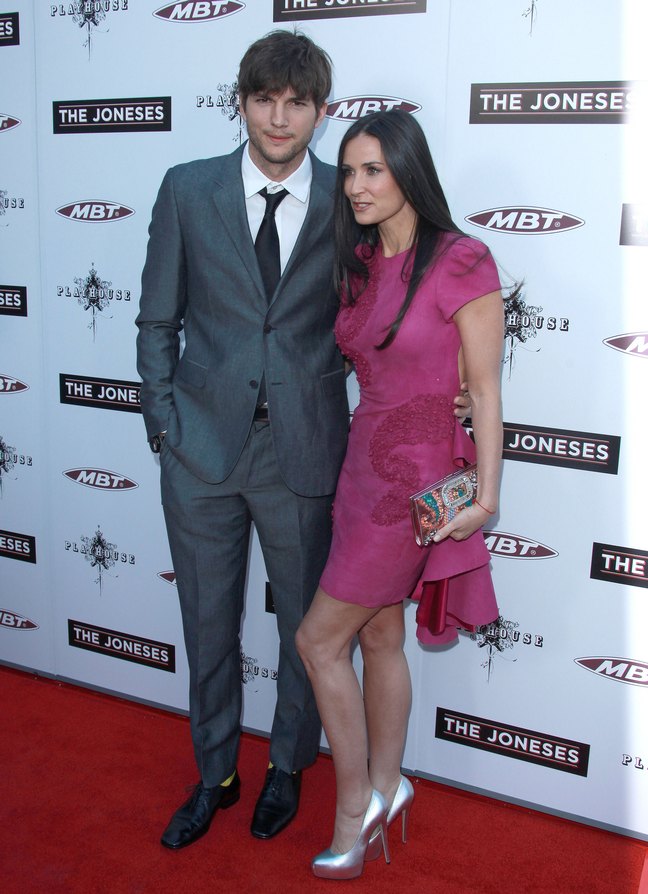 Demi Moore, pink dress, silver high heels, multi-colored clutch, Ashton Kutcher, gray suit, yellow socks